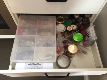 Spice drawer full of expired, plastic wrapped spices